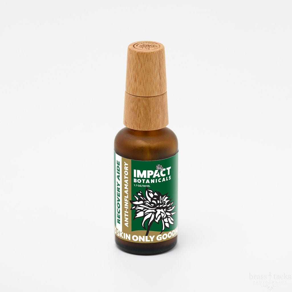 Amber glass bottle of Impact Botanicals Recovery Aide anti-inflammatory skin treatment with bamboo lid.