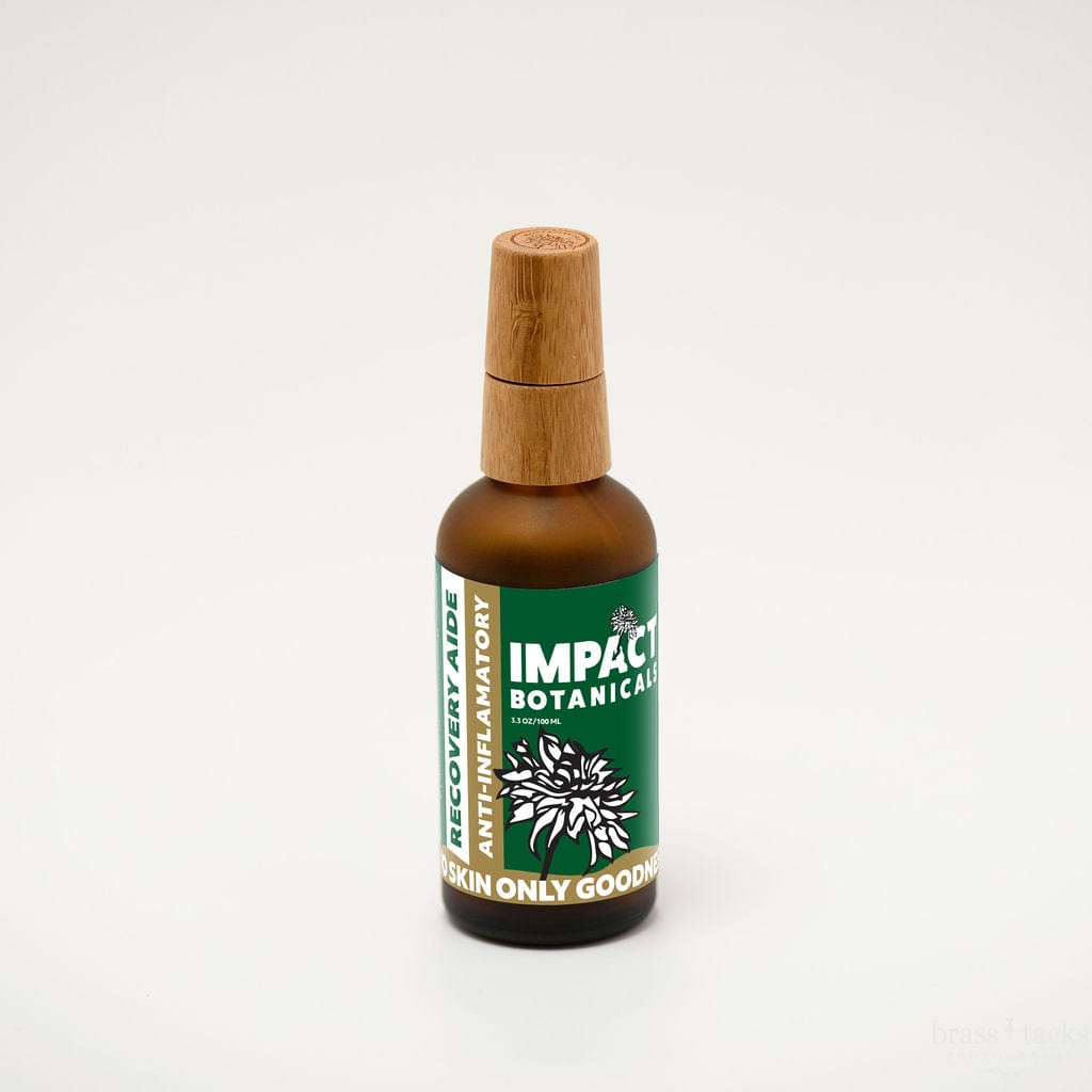 Amber bottle of Impact Botanicals Recovery Aide anti-inflammatory serum with bamboo cap stands on white background.