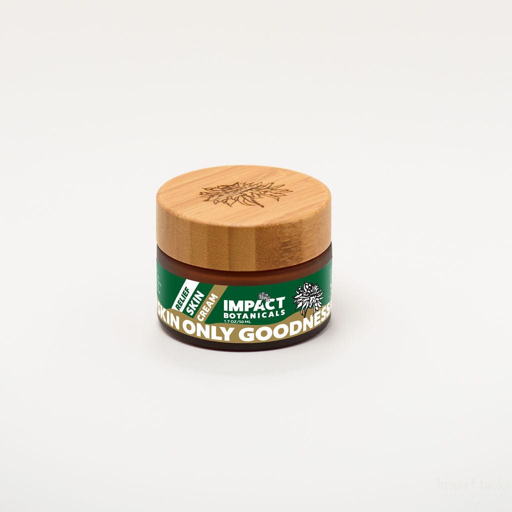 Amber jar of Impact Botanicals Relief Skin Cream with a bamboo lid.