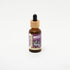 Amber glass bottle of Impact Botanicals Trifecta Breast Serum with a bamboo dropper top.