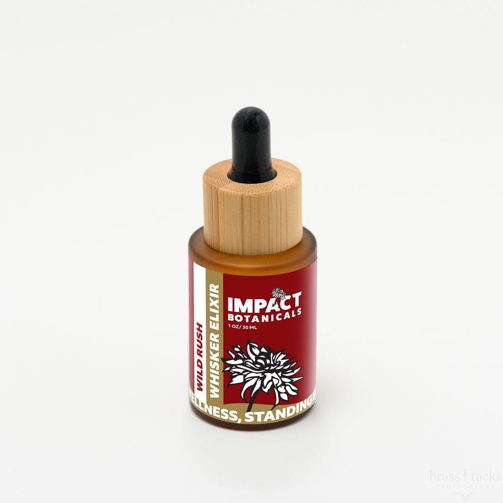 Amber glass bottle of Impact Botanicals Wild Rush Whisker Elixir with dropper top and bamboo cap.