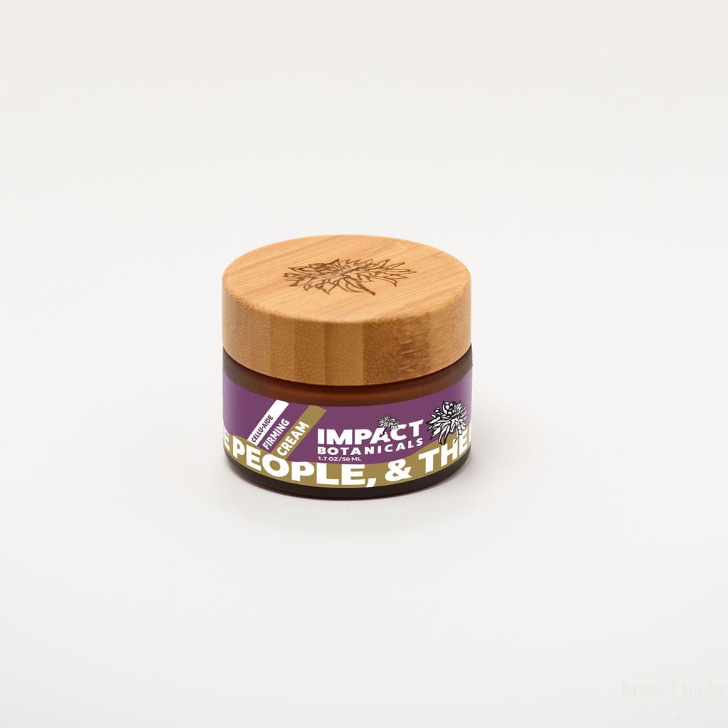 Amber jar of Impact Botanicals Cellulite Firming Cream with a bamboo lid.