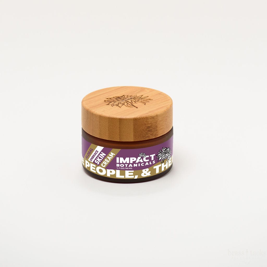 A jar of Impact Botanicals Floral Embrace Skin Cream with a bamboo lid sits on a white background.
